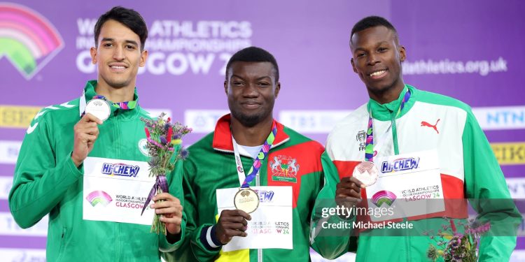 GLASGOW, SCOTLAND - MARCH 03:  Silver medallist Yasser Mohammed Triki of Team Algeria, gold medallist Hugues Fabrice Zango of Team Burkina Faso and bronze medallist Tiago Pereira of Team Portugal pose for a photo during the medal ceremony for the Men's Triple Jump Final on Day Three of the World Athletics Indoor Championships Glasgow 2024 at Emirates Arena on March 03, 2024 in Glasgow, Scotland. (Photo by Michael Steele/Getty Images)