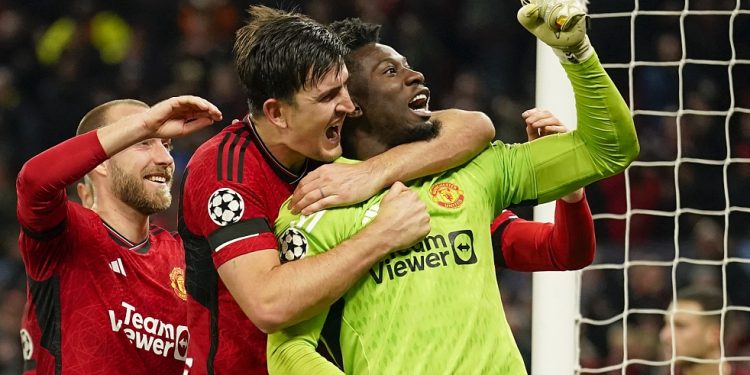 Manchester United's goalkeeper Andre Onana, right, celebrates with teammates after makes a save penalty shoot during the Champions League group A soccer match between Manchester United and Copenhagen at the Old Trafford stadium in Manchester, England, Tuesday, Oct. 24, 2023. (AP Photo/Dave Thompson)