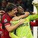 Manchester United's goalkeeper Andre Onana, right, celebrates with teammates after makes a save penalty shoot during the Champions League group A soccer match between Manchester United and Copenhagen at the Old Trafford stadium in Manchester, England, Tuesday, Oct. 24, 2023. (AP Photo/Dave Thompson)