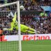 Arsenal's Spanish goalkeeper #22 David Raya dives as the ball comes back off the crossbar from a deflected shot from Aston Villa's Belgian defender #24 Amadou Onana during the English Premier League football match between Aston Villa and Arsenal at Villa Park in Birmingham, central England on August 24, 2024. (Photo by Adrian DENNIS / AFP) / RESTRICTED TO EDITORIAL USE. No use with unauthorized audio, video, data, fixture lists, club/league logos or 'live' services. Online in-match use limited to 120 images. An additional 40 images may be used in extra time. No video emulation. Social media in-match use limited to 120 images. An additional 40 images may be used in extra time. No use in betting publications, games or single club/league/player publications. /  (Photo by ADRIAN DENNIS/AFP via Getty Images)